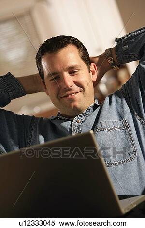Man sitting with laptop computer View Large Photo Image Stock Photography - Man sitting with laptop computer. Fotosearch