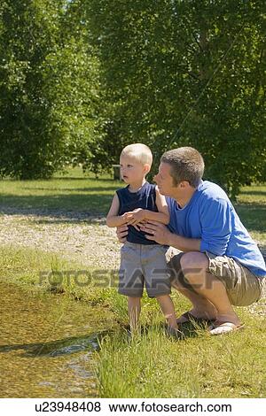Stock Photo - Man with his son in a park. Fotosearch