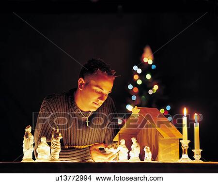 Man with nativity scene figurines and lights View Large Photo Image Picture - Man with nativity scene figurines and lights. Fotosearch