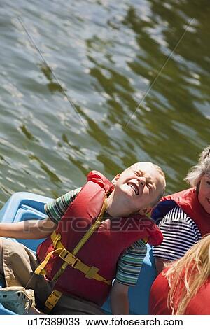 Stock Image - Overhead view of a boy boating. Fotosearch