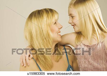 Portrait of a mother and young daughter looking at one another View Large Photo Image Stock Photography - Portrait of a mother and young daughter looking at one another. Fotosearch