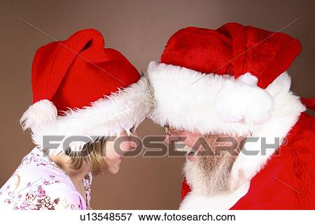 Profile of a girl with Santa Claus View Large Photo Image Stock Photo - Profile of a girl with Santa Claus. Fotosearch