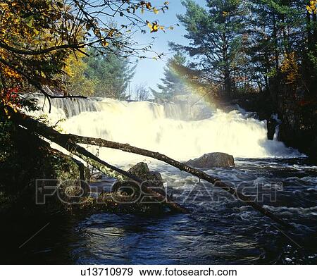 Stock Photo - Rapids with rainbow, Quebec, Canada. Fotosearch