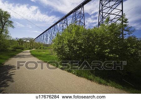 Picture - Road alongside a railway bridge in Lethbridge, Alberta. Fotosearch