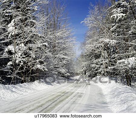 Stock Image - Rural road in winter, Eastern Townships, Quebec, Canada. Fotosearch