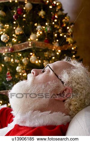 Santa Claus asleep by the Christmas tree View Large Photo Image Stock Photography - Santa Claus asleep by the Christmas tree. Fotosearch