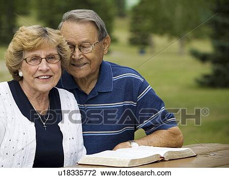 Stock Image - Senior couple with their Bible. Fotosearch