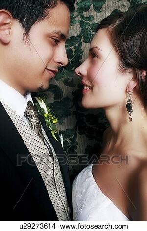 Side view of a couple smiling View Large Photo Image Picture - Side view of a couple smiling. Fotosearch