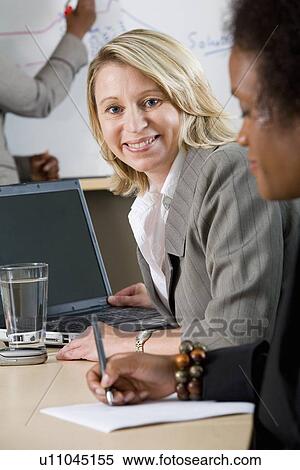 Side view of businesswoman smiling View Large Photo Image Stock Photography - Side view of businesswoman smiling. Fotosearch