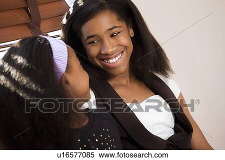 Sisters laughing together View Large Photo Image Stock Photography - Sisters laughing together. Fotosearch