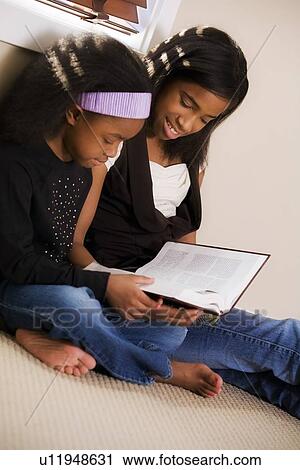 Sisters reading the Bible View Large Photo Image Stock Image - Sisters reading the Bible. Fotosearch