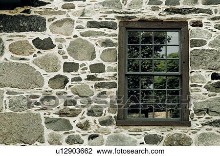 Stock Image - Stone wall with a window. Fotosearch
