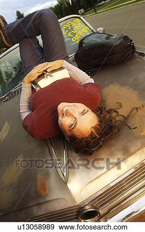 Stock Photo - Student enjoying purchase of first car. Fotosearch