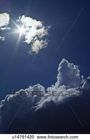 Stock Image - Sunburst through the clouds. Fotosearch
