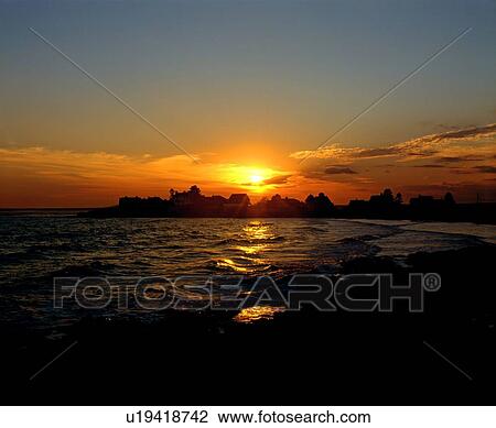 Stock Image - Sunrise on the coast. Fotosearch