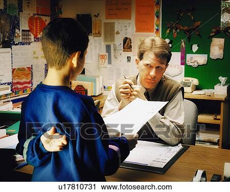Stock Image - Teacher talking to student. Fotosearch