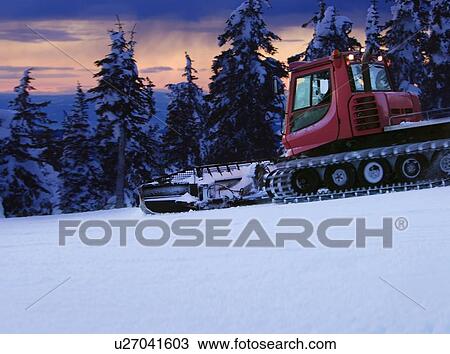 Stock Image - Tractor in a snowy field. Fotosearch