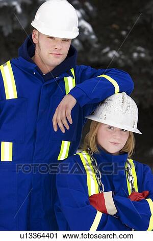 Tradesman and junior tradeswoman View Large Photo Image Stock Image - Tradesman and junior tradeswoman. Fotosearch