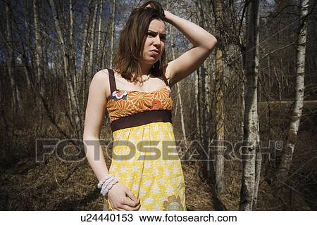 Troubled woman in wooded area View Large Photo Image Stock Image - Troubled woman in wooded area. Fotosearch