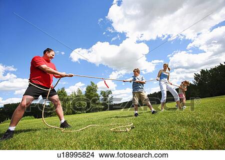 Tug of war between dad and kids View Large Photo Image Picture - Tug of war between dad and kids. Fotosearch