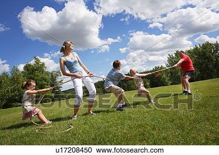 Tug of war between dad and mom with kids View Large Photo Image Stock Image - Tug of war between dad and mom with kids. Fotosearch