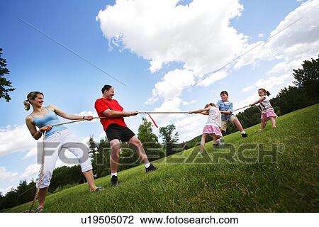 Stock Image - Tug of war between parents and kids. Fotosearch