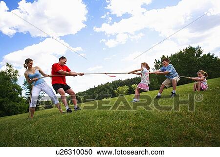Tug of war between parents and kids View Large Photo Image Stock Image - Tug of war between parents and kids. Fotosearch