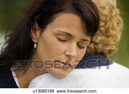 Two people embracing View Large Photo Image Stock Photo - Two people embracing. Fotosearch