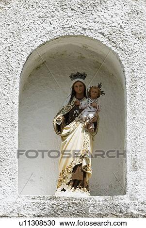Stock Image - Virgin Mary and Christ child in a stone niche, Northern Spain. Fotosearch