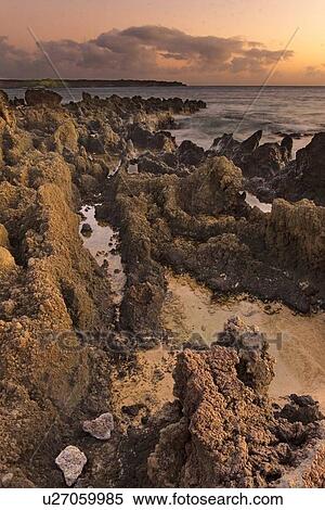 Volcanic rocks on beach and clouds on the horizon View Large Photo Image Stock Photography - Volcanic rocks on beach and clouds on the horizon. Fotosearch