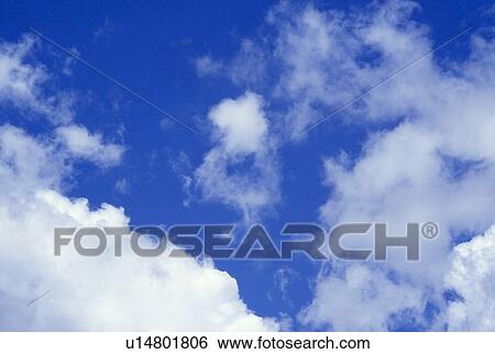 Stock Photograph - White clouds in a blue sky. Fotosearch