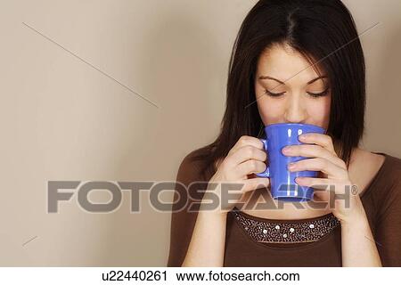 Woman drinking a hot drink View Large Photo Image Stock Image - Woman drinking a hot drink. Fotosearch
