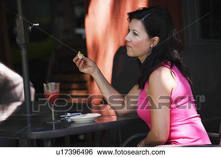 Woman eating alone View Large Photo Image Stock Photograph - Woman eating alone. Fotosearch