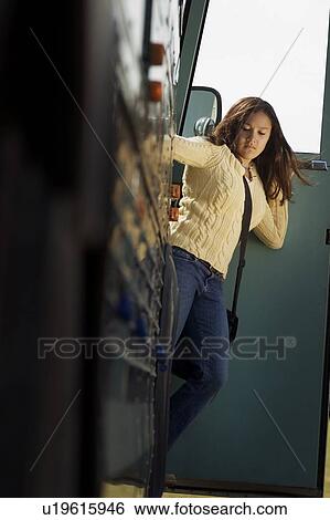 Woman getting off a bus View Large Photo Image Stock Photograph - Woman getting off a bus. Fotosearch