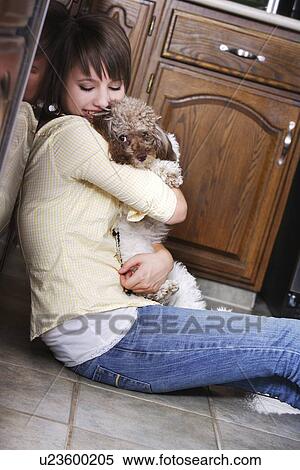 Stock Photography - Woman holding a dog. Fotosearch