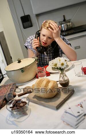 Picture - Woman in a 1940's style kitchen. Fotosearch