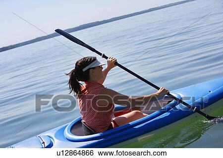 Stock Photograph - Woman kayaking. Fotosearch