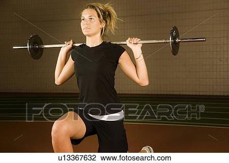 Woman lifting weights View Large Photo Image Stock Image - Woman lifting weights. Fotosearch