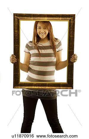 Woman posing with picture frame View Large Photo Image Stock Photograph - Woman posing with picture frame. Fotosearch