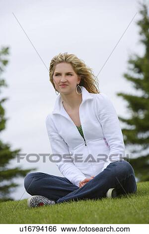 Woman sitting on lawn View Large Photo Image Stock Photograph - Woman sitting on lawn. Fotosearch