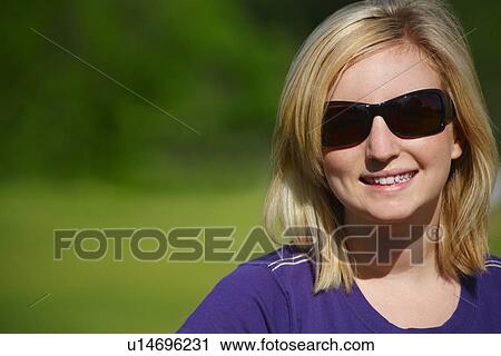 Woman wearing sunglasses View Large Photo Image Stock Image - Woman wearing sunglasses. Fotosearch