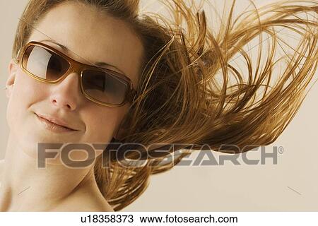 Stock Image - Woman wearing sunglasses. Fotosearch