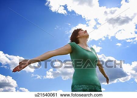 Stock Image - Woman with arms outstretched. Fotosearch