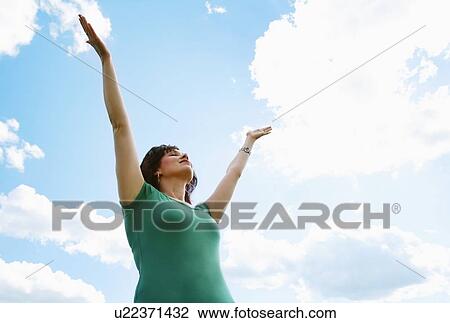 Woman with arms raised View Large Photo Image Stock Image - Woman with arms raised. Fotosearch