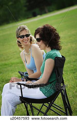 Stock Image - Women sitting together. Fotosearch