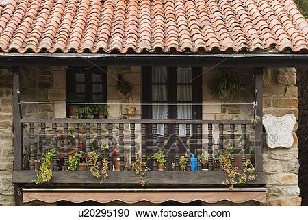 Stock Image - Wooden balcony on stone house in village of Barcena Mayor, Cantabria, Northern Spain. Fotosearch