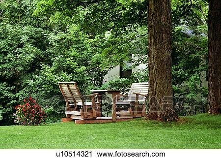 Wooden chairs set up in a yard View Large Photo Image Stock Image - Wooden chairs set up in a yard. Fotosearch
