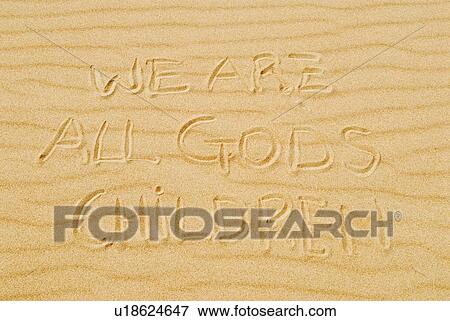 Stock Photo - Words in sand that state "we are all God's children". Fotosearch