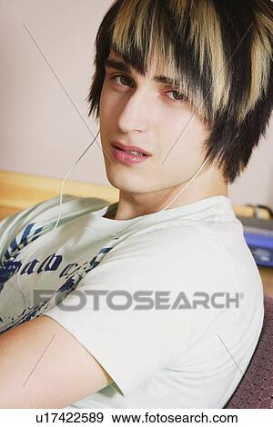 Young adult listening to music View Large Photo Image Stock Photo - Young adult listening to music. Fotosearch