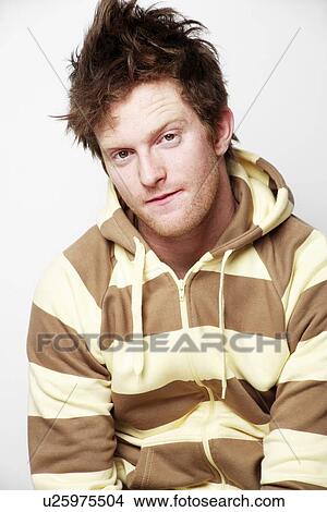 Picture - Young adult male posing in fashionable striped sweater. Fotosearch